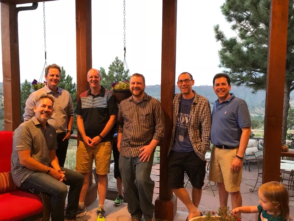 Members of the Anonos engineering team gathered on a mountain-view porch during an off-site strategy meeting.